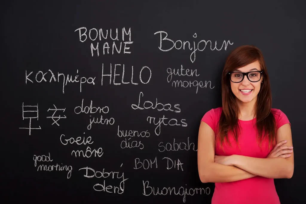 blackboard filling with different languages and smiling lady in red